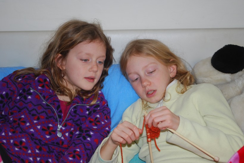 Lily learned how to knit last week.  Sylvia, who has been knitting for more than a year, gave her some pointers.