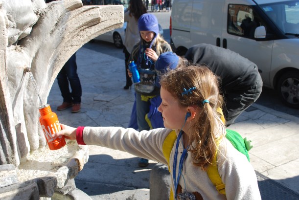 Filling up our water bottles at one of public water fountains that are all over Rome.