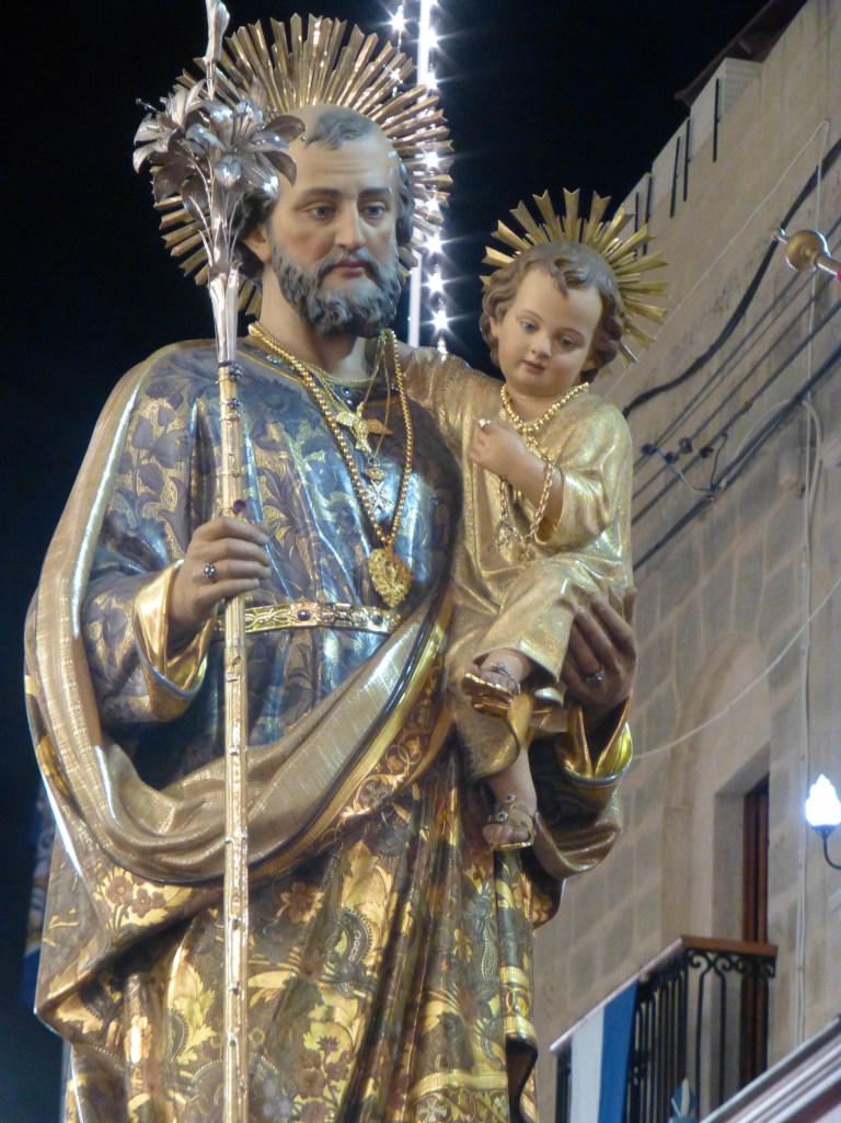 St. Joseph.  It was Sylvia and Lily who pointed out that this is the Joseph that raised Jesus.  I just figured it was some random saint, but the girls recognized the baby as Jesus.  I guess Sunday school is paying off! :) 