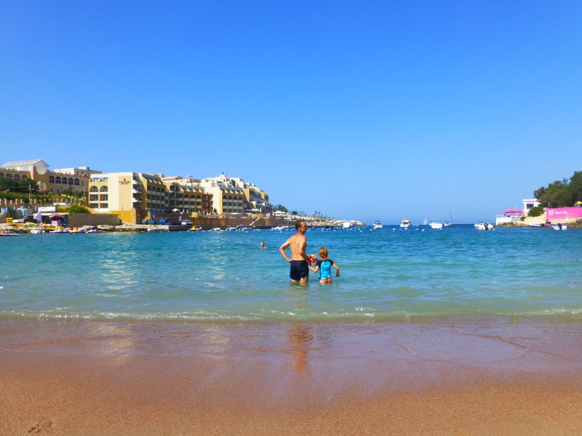 Lily loves to play in the sand but is getting more comfortable being out in the water.