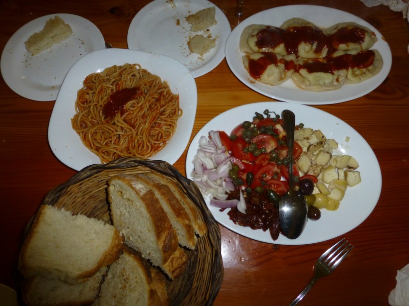 A simple and delicious Maltese meal: Maltese bread (hobz), pasta, cheese and a plate full of olives, sundried tomatoes and onions.