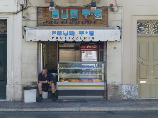 A typical pastizzi shop where you can buy these delicious little treats for only 30 cents (Euro).  A pastizzi is phyllo pastry filled with ricotta cheese.  There are lots of variations which include peas, chicken, onions, other meat and more.  These stands also usually sell pizza by the slice and other tasty street food.