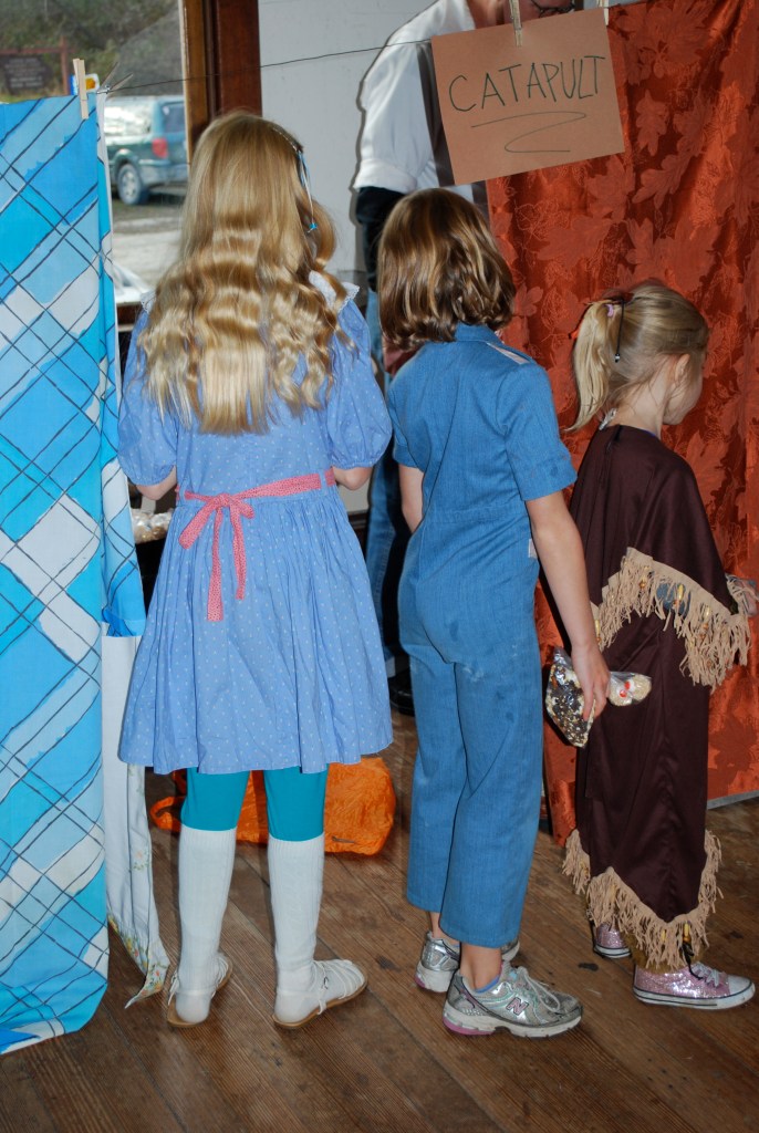 Waiting in line to play a game at a booth. 