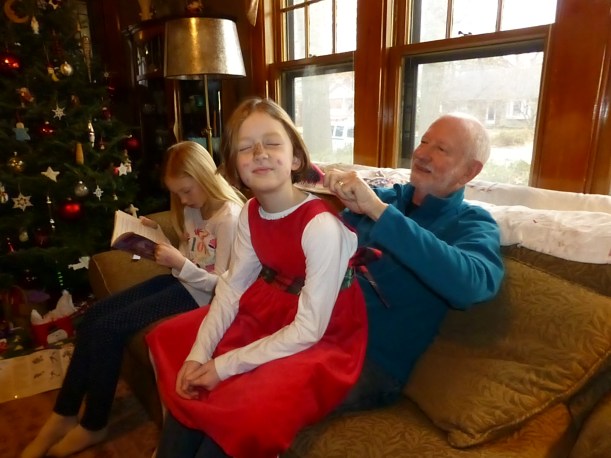 Grandpa Bruce brushing Lily's hair on Christmas Eve. My sister Mikaela took the girls to the Children's Museum, hence the face paint. It came off before church. :)