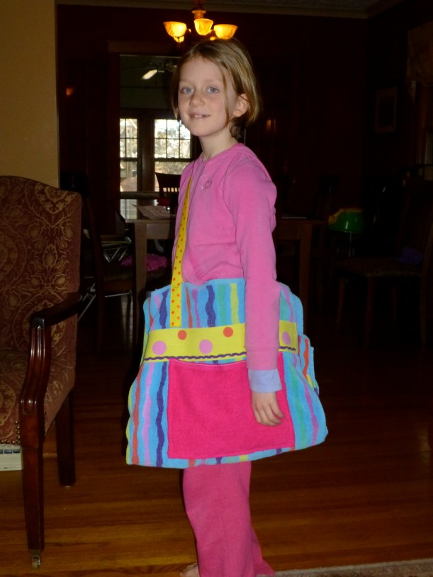 Lily's bag is a beach towel folded up with a pocket and handles.